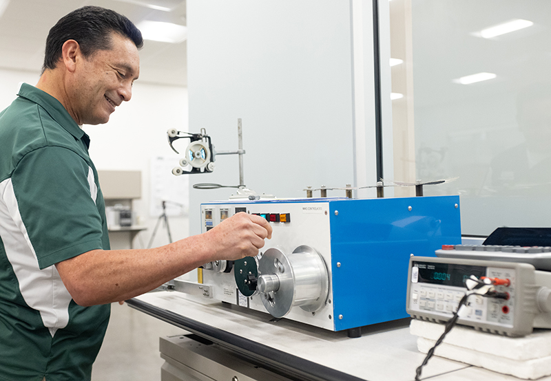 A man working on a machine in a lab.